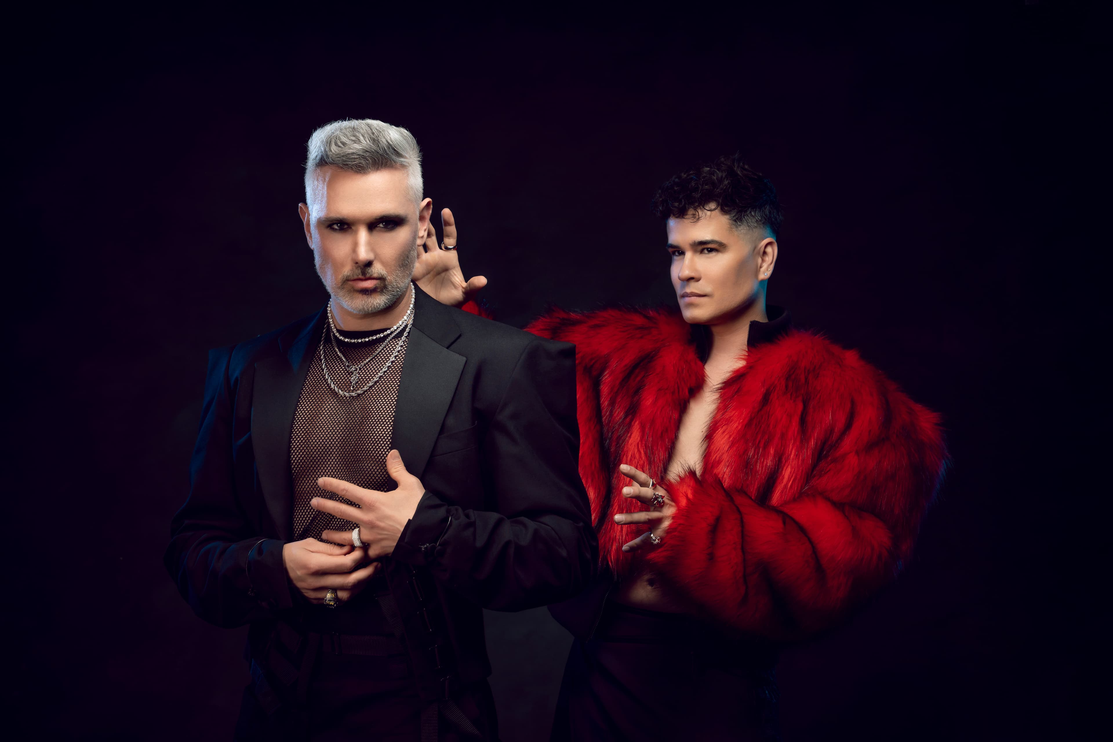 Velvet Riot — duo portrait, dark studio, red fur and black mesh.