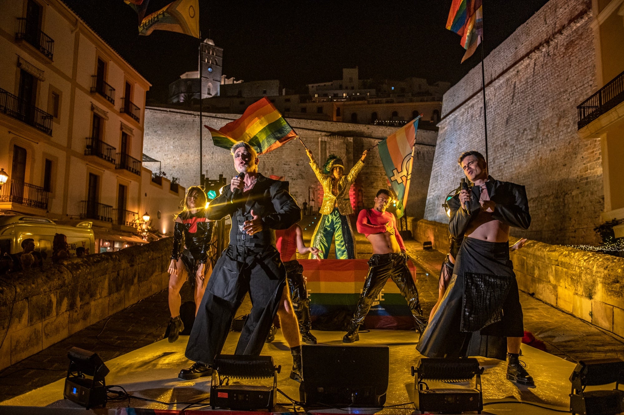 Ibiza Pride 2026 — the dancers airborne at the old town walls.