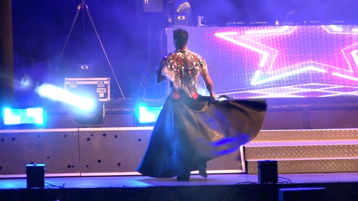 Long black skirt against the star backdrop.